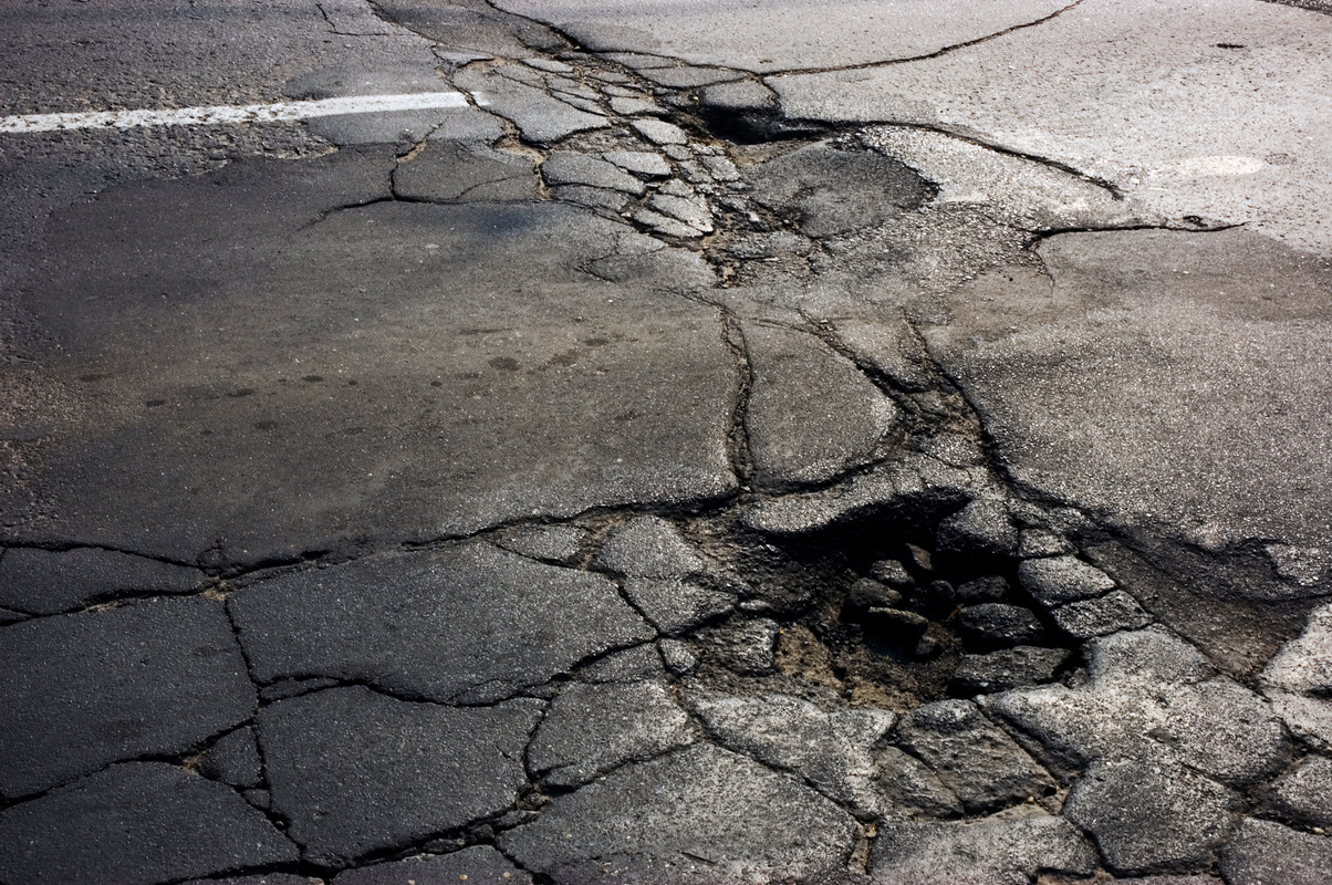 Cracked Asphalt and Potholes